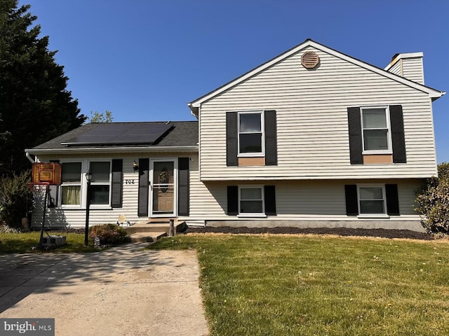 702 Rainbow Ct, Edgewood, MD 21040 - split level home featuring a front lawn, roof mounted solar panels, and a chimney