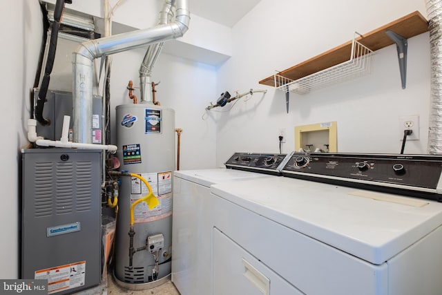 laundry room with heating unit, gas water heater, laundry area, and independent washer and dryer