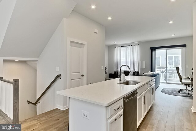1701 Beech Leaf St, Dumfries, VA 22026 - kitchen featuring a sink, light wood finished floors, open floor plan, white cabinetry, and an island with sink