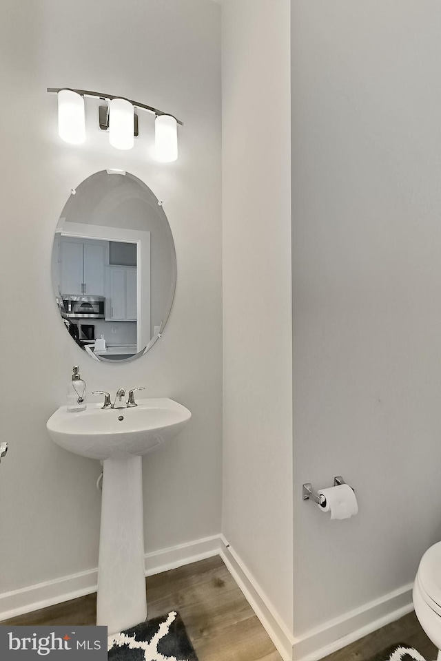 1701 Beech Leaf St, Dumfries, VA 22026 - bathroom with baseboards, wood finished floors, and toilet