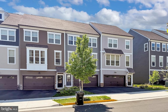 1701 Beech Leaf St, Dumfries, VA 22026 - townhome / multi-family property featuring board and batten siding, a garage, and driveway