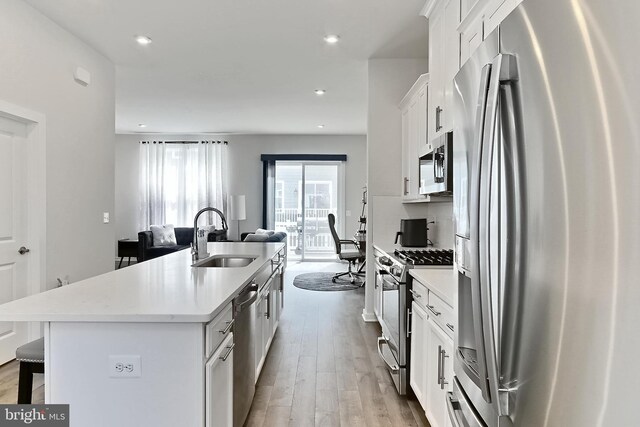 1701 Beech Leaf St, Dumfries, VA 22026 - kitchen with stainless steel appliances, a sink, a kitchen bar, open floor plan, and a center island with sink