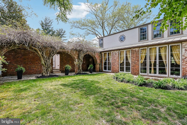 33 Rosedale Rd, Princeton, NJ 08540 - view of front of house featuring metal roof, a standing seam roof, brick siding, and a front lawn