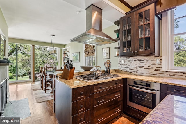 33 Rosedale Rd, Princeton, NJ 08540 - kitchen with dark brown cabinets, island exhaust hood, a peninsula, a chandelier, and appliances with stainless steel finishes