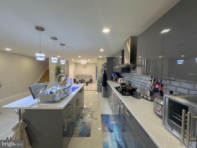 kitchen with island range hood, pendant lighting, modern cabinets, a center island with sink, and black gas cooktop