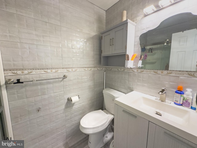 bathroom with backsplash, tile walls, a stall shower, vanity, and toilet