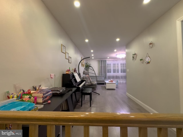 interior space featuring recessed lighting, baseboards, and wood finished floors