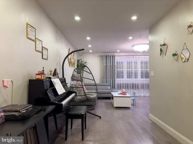 interior space featuring recessed lighting, baseboards, and wood finished floors