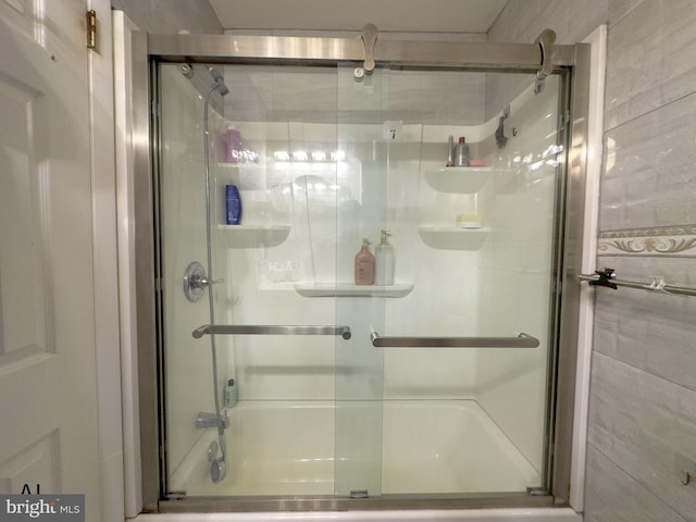 bathroom featuring a shower with shower door