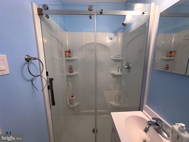 full bath with a shower stall and vanity