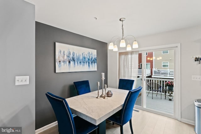 209 Sheridan St, Taneytown, MD 21787 - dining space with baseboards, light wood finished floors, and a chandelier