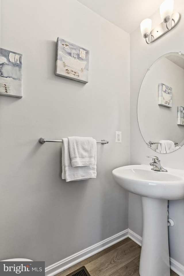 209 Sheridan St, Taneytown, MD 21787 - bathroom with wood finished floors, baseboards, and a sink