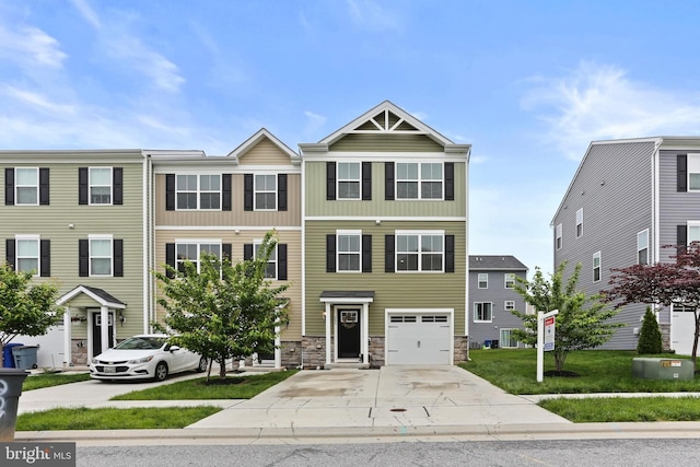 209 Sheridan St, Taneytown, MD 21787 - view of property featuring concrete driveway, an attached garage, stone siding, and central air condition unit