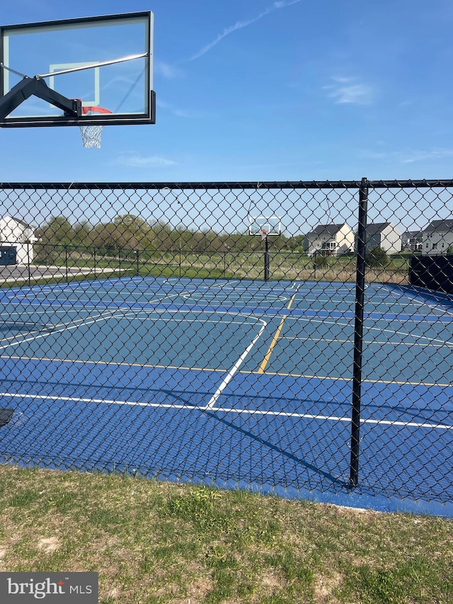 view of basketball court featuring fence and community basketball court