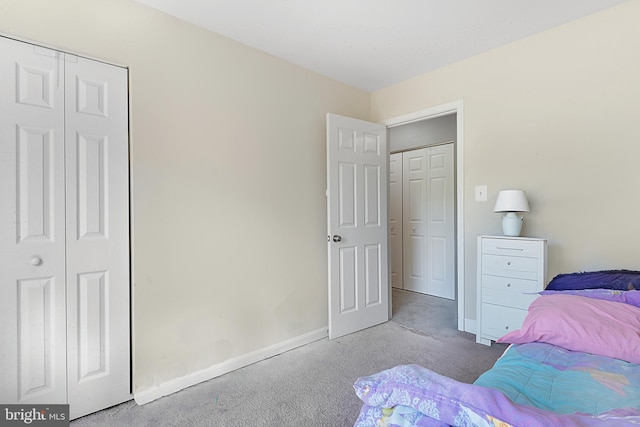 carpeted bedroom with baseboards