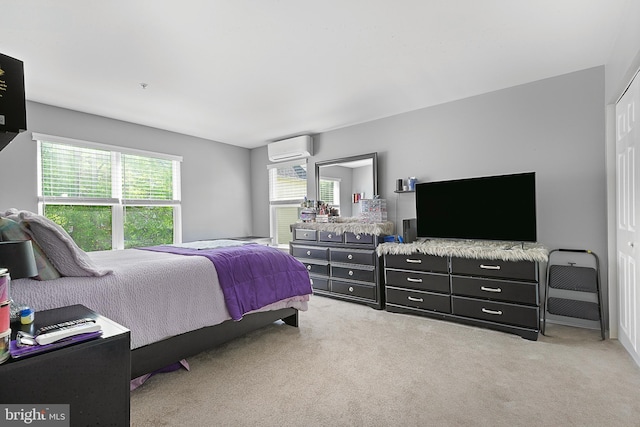 bedroom featuring light colored carpet and a wall mounted air conditioner