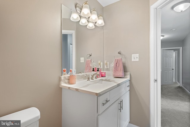 half bath with vanity, toilet, and baseboards
