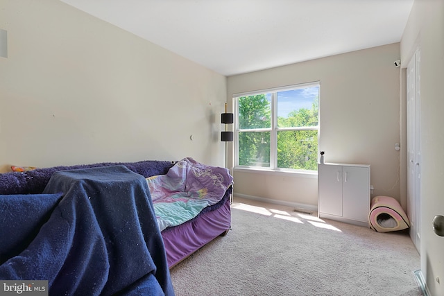 carpeted bedroom featuring baseboards and visible vents