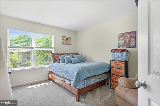 carpeted bedroom with baseboards and visible vents