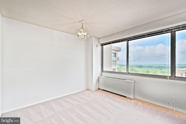 5500 Friendship Blvd Unit 2321N, Chevy Chase, MD 20815 - carpeted spare room featuring radiator, a chandelier, a textured ceiling, and baseboards