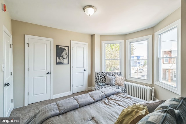 226 N 64th St, Philadelphia, PA 19139 - bedroom featuring baseboards, carpet flooring, and radiator