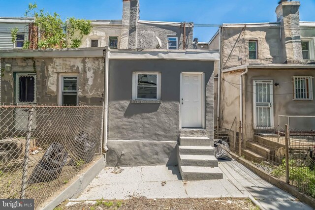 226 N 64th St, Philadelphia, PA 19139 - rear view of property featuring fence and stucco siding