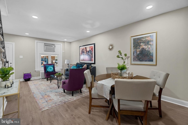 226 N 64th St, Philadelphia, PA 19139 - dining area with baseboards, an AC wall unit, recessed lighting, and wood finished floors