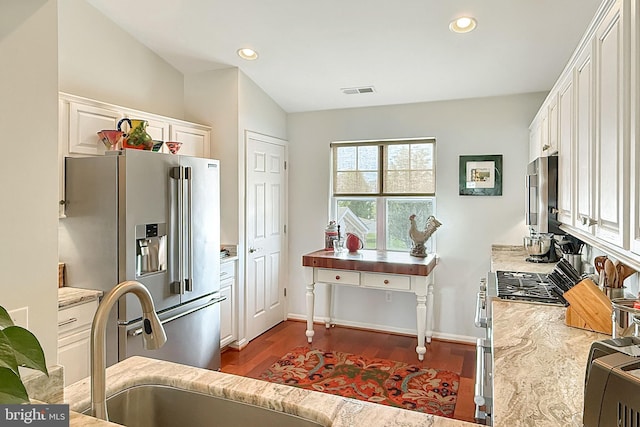 kitchen featuring dark wood-style flooring, white cabinetry, recessed lighting, high end appliances, and visible vents