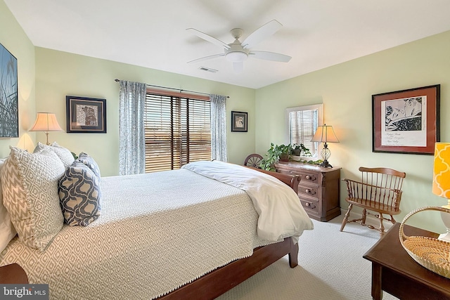 bedroom with visible vents, a ceiling fan, and carpet floors