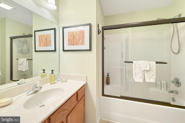 full bath featuring bath / shower combo with glass door and vanity