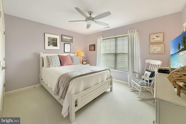 bedroom with baseboards, a ceiling fan, light colored carpet, and visible vents
