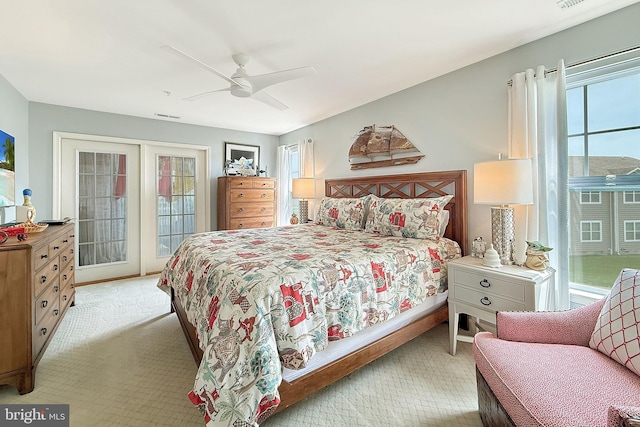 bedroom featuring carpet floors, multiple windows, a ceiling fan, and access to exterior