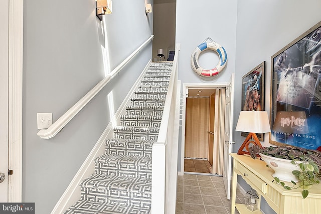 staircase featuring tile patterned floors
