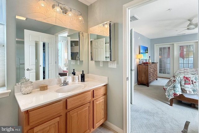 full bathroom with a ceiling fan, visible vents, vanity, baseboards, and connected bathroom