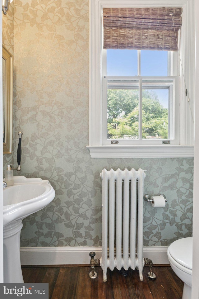 1847 Lamont St NW, Washington, DC 20010 - bathroom with radiator, wallpapered walls, healthy amount of natural light, and wood finished floors