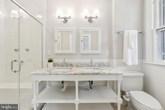 1847 Lamont St NW, Washington, DC 20010 - bathroom with a shower stall, a wainscoted wall, tile walls, and double vanity