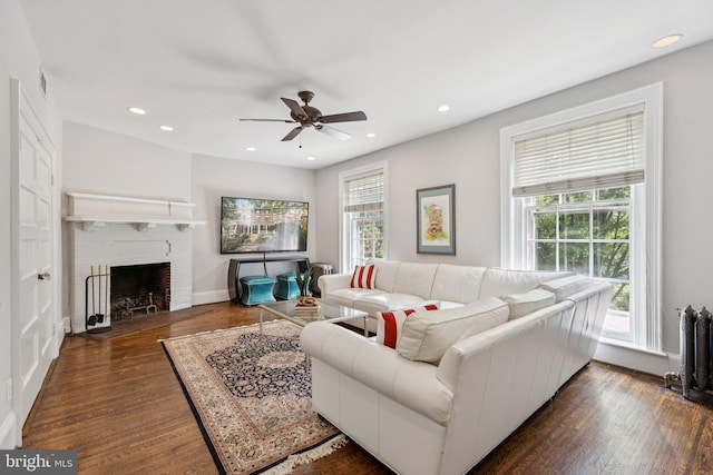 1847 Lamont St NW, Washington, DC 20010 - living area featuring dark wood-type flooring, a ceiling fan, recessed lighting, a fireplace, and radiator heating unit