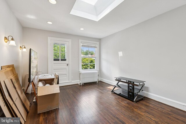 1847 Lamont St NW, Washington, DC 20010 - living area featuring radiator heating unit, a skylight, hardwood / wood-style floors, and recessed lighting
