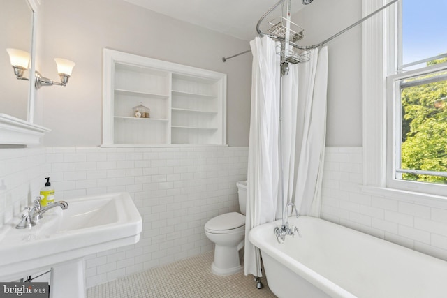 1847 Lamont St NW, Washington, DC 20010 - full bath with tile walls, a soaking tub, plenty of natural light, tile patterned flooring, and a wainscoted wall