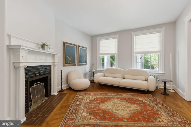 1847 Lamont St NW, Washington, DC 20010 - living room featuring a fireplace with flush hearth, wood finished floors, and radiator heating unit