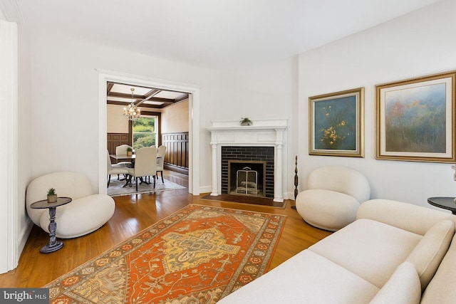 1847 Lamont St NW, Washington, DC 20010 - living room with a chandelier, wood finished floors, coffered ceiling, beam ceiling, and a fireplace with flush hearth