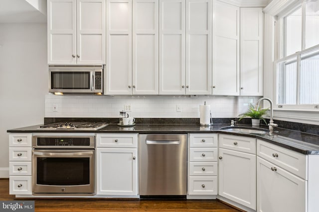 1847 Lamont St NW, Washington, DC 20010 - kitchen featuring stainless steel appliances, white cabinets, and tasteful backsplash