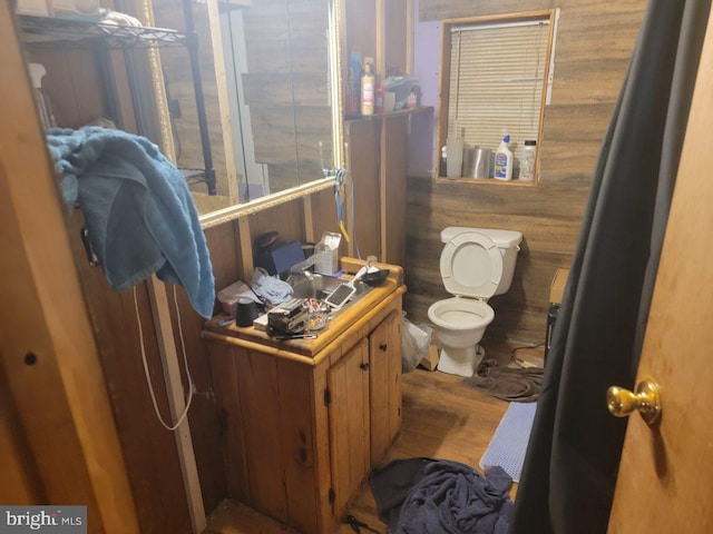 bathroom with toilet and wood finished floors