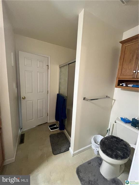 full bath with toilet, baseboards, a shower stall, and visible vents