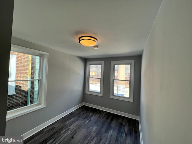 2109 E Tioga St, Philadelphia, PA 19134 - empty room featuring healthy amount of natural light, baseboards, and dark wood-style floors