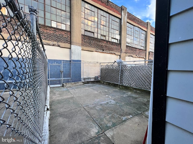 2109 E Tioga St, Philadelphia, PA 19134 - view of side of property featuring fence, brick siding, and a patio