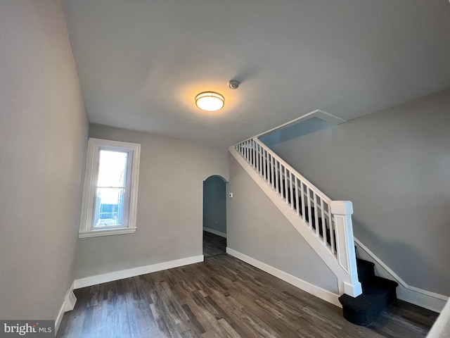 2109 E Tioga St, Philadelphia, PA 19134 - stairs with arched walkways, wood finished floors, and baseboards