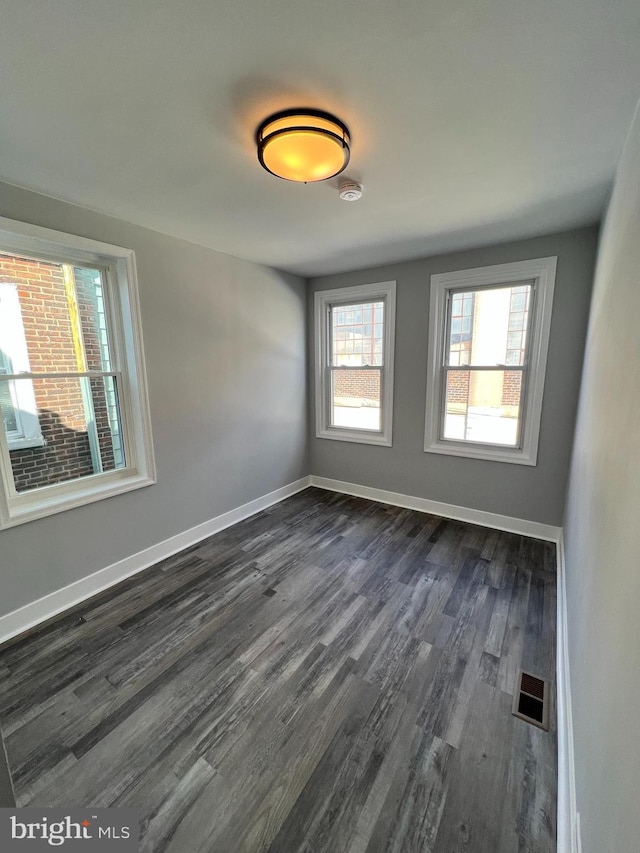 2109 E Tioga St, Philadelphia, PA 19134 - spare room featuring dark wood finished floors, baseboards, and a smoke detector