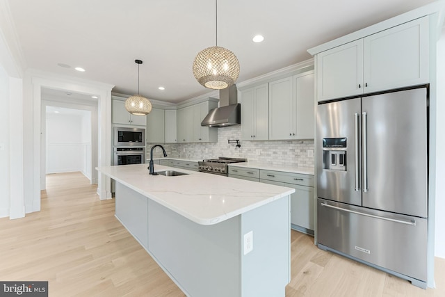 4763 Williamsburg Blvd, Arlington, VA 22207 - kitchen featuring stainless steel appliances, a sink, wall chimney exhaust hood, light wood-style floors, and backsplash