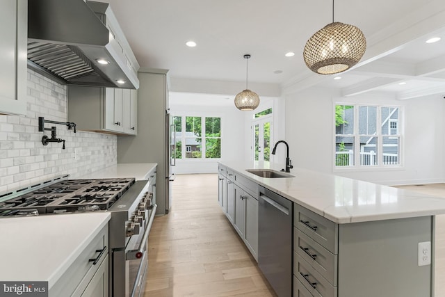 4763 Williamsburg Blvd, Arlington, VA 22207 - kitchen with a sink, appliances with stainless steel finishes, wall chimney range hood, gray cabinets, and decorative backsplash